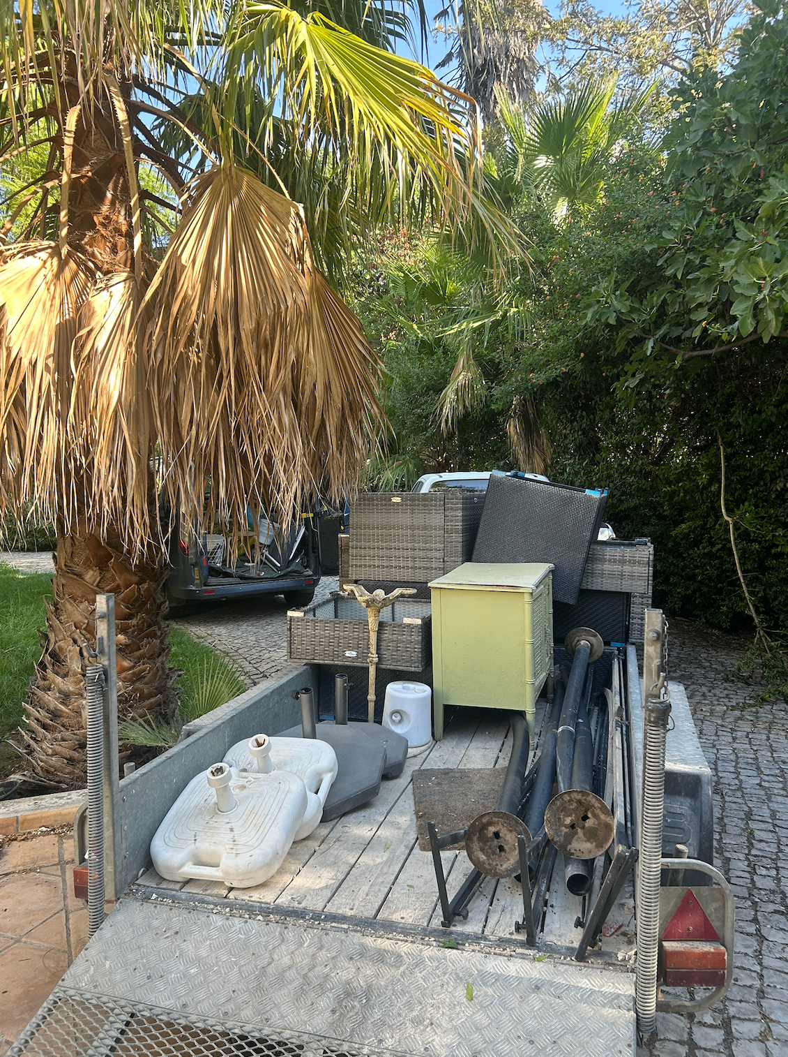 Trailer loaded with garden furniture and rubbish for removal in Almancil