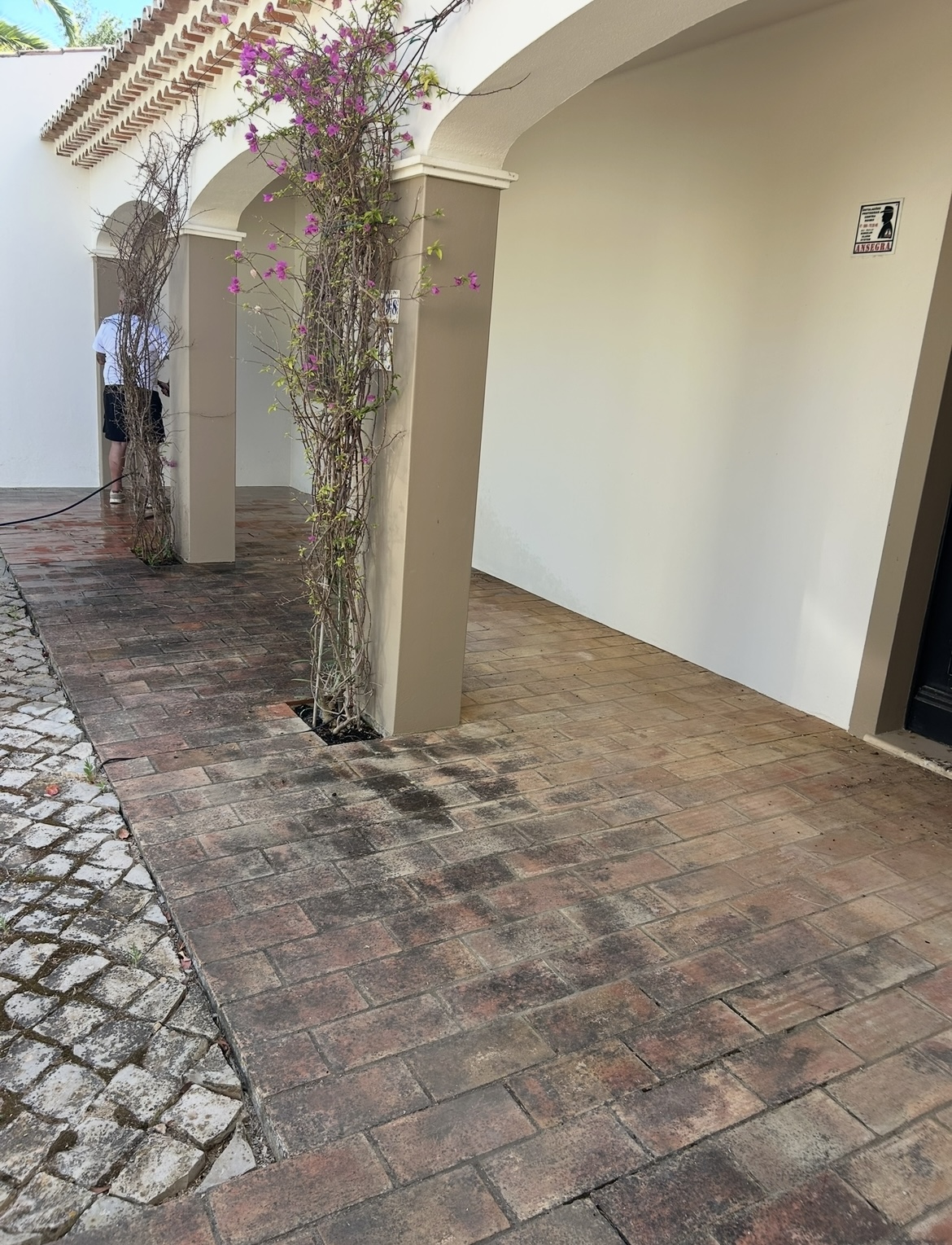 Before: Arched entryway brick courtyard pressure washing Algarve